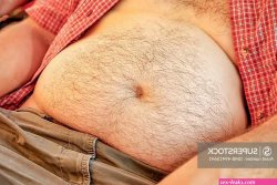 Naked and hairy belly of a middle-aged man representative of the type Dad Bod