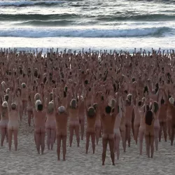 Bondi becomes nude beach as thousands take part in Spencer Tunicks Sydney installation