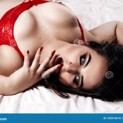 Woman Plus Size Model in Lingerie on Bed. Chubby Girl in Un Stock Photo